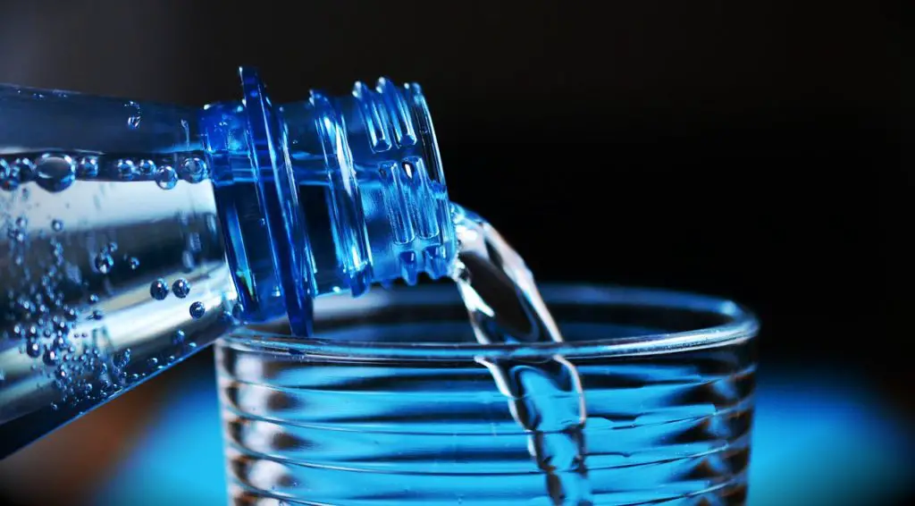 Pouring Water in a Glass from Bottle