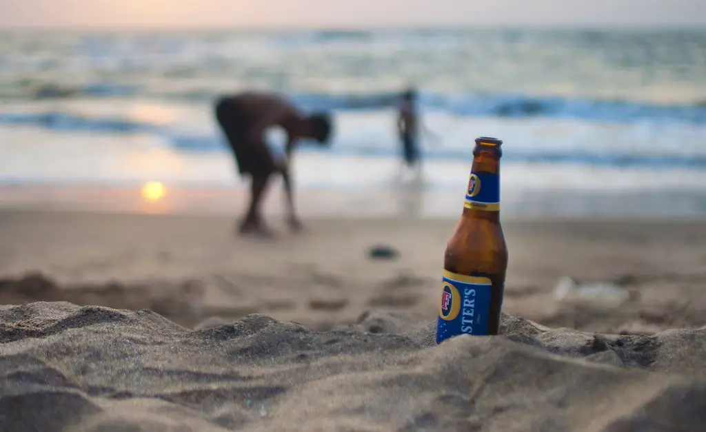 Bottle of Beer On a Beach During Sunset