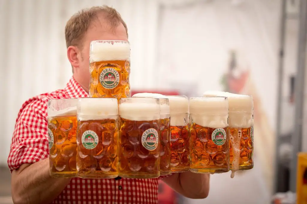 Man Carrying Beer Pints