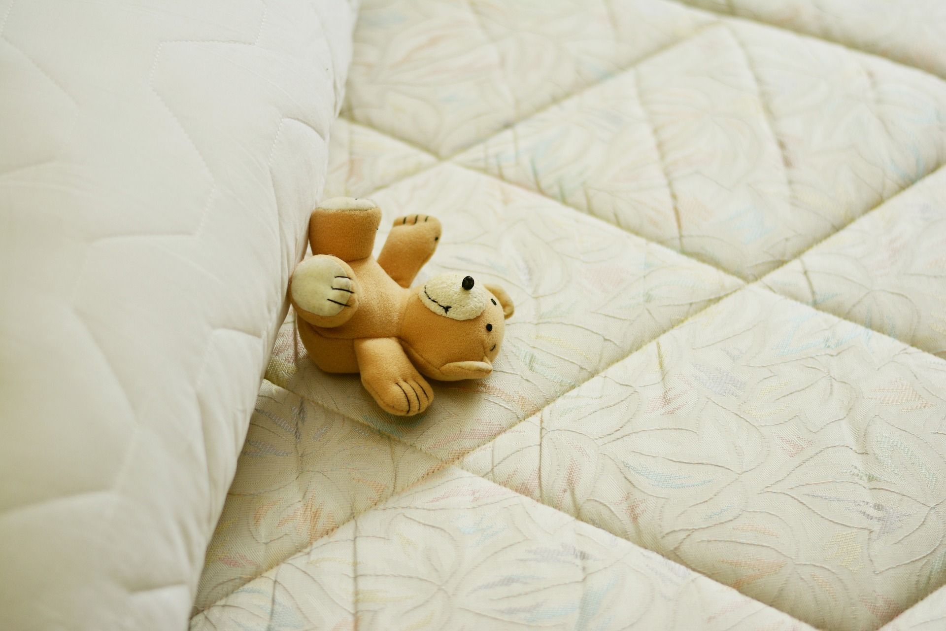 Teddy Bear Sleeping on a Mattress